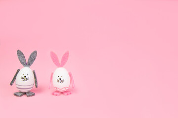 Easter. Easter bunnies, with their own hands on a pink background. Concept mocap and banner, congratulation, advertisement, invitation. High quality photo