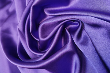 Purple crumpled or wavy fabric texture background. Abstract linen cloth soft waves. Silk atlas or stretch jacquard. Smooth elegant luxury cloth texture. Concept for banner or advertisement.