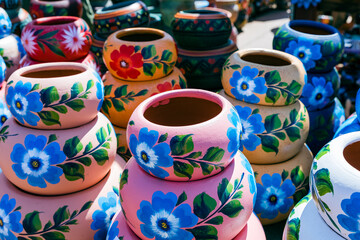 Variety of Colorfully Mexican Painted Ceramic Pots in an Outdoor Shopping Souvenir Market in Mexico.