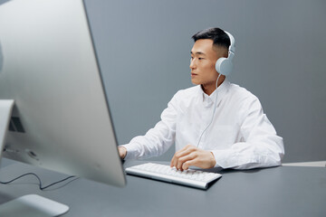 worker in front of the computer with headphones emotions Lifestyle work