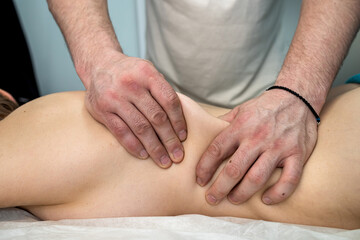 Fototapeta na wymiar male massager therapist doing therapeutic back massage ot client in spa clinic