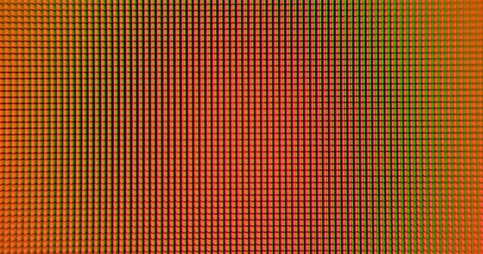Change the color of orange, blue and green on the monitor pixel squares. Focus in the center of the frame. Dynamic video effect.