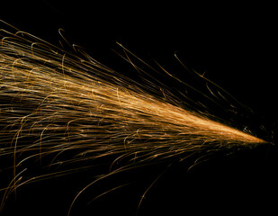 red fast-flying sparks from angle grinders on black background