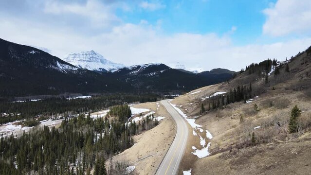 open road in the mountains, blue sky trees, Alberta Canada 