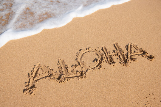 Aloha written in sand