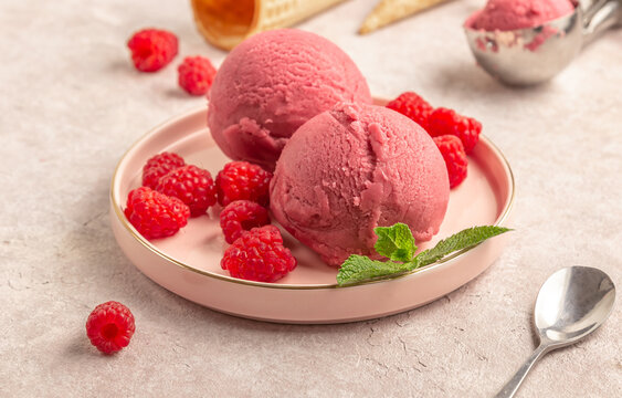 Raspberry ice cream with fresh raspberries and mint