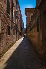Fototapeta na wymiar VENICE, ITALY - August 27, 2021: View of narrow and historic alley in the center of Venice