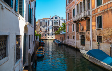 View of empty canals of Venice with apartment buildings in the background