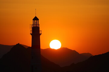 Seascape at sunshine. Lighthouse and sailings on the coast. Seaside town of Turgutreis and spectacular sunshine	
