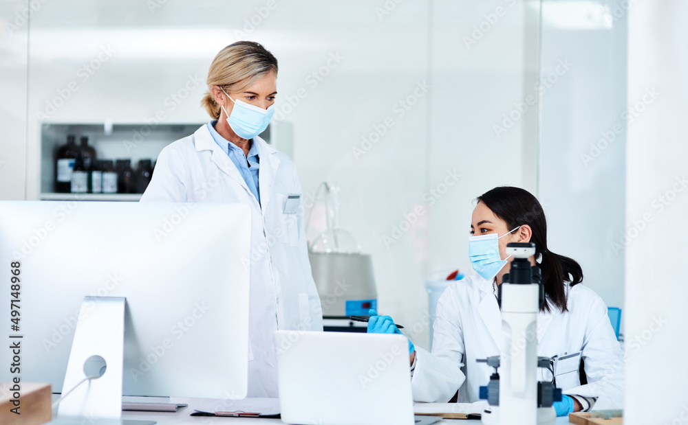Poster Working on new research. Shot of two scientists working together in a lab.