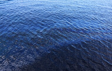 Large oil slick on blue surface poses danger to the inhabitants of the seas and oceans