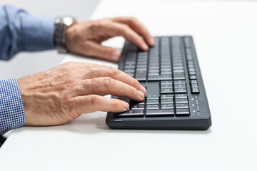 Close up of businessman hands typing on computer keyboard.Business, education, programming