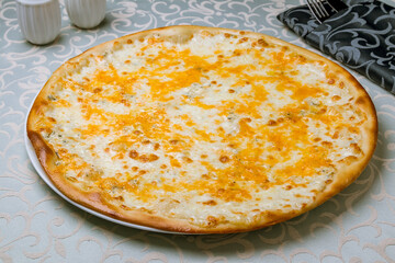 Pizza Quattro formaggi on white plate