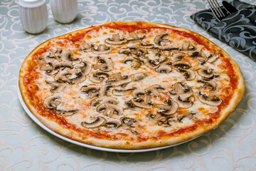 pizza with mushrooms and cheese on table