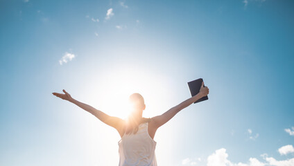 Strong, happy motivated woman holding bible 