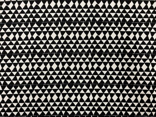 Black and white fabric. Tooth pattern. Simple pattern with black drawn triangles on white background. Triangles.