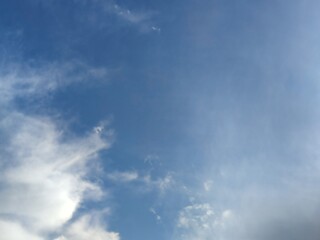 Layered clouds against the sky. Multilevel white clouds are floating in the light blue sky. Clouds of different shapes and sizes are illuminated by the sun and they are fluffy in appearance.