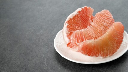 Pomelo Fruit on Plate. Grapefruit, jeruk Bali, or Bali Pomelo Fruit. Large Oranges in Indonesia are known as Bali Oranges or Jeruk Bali.
