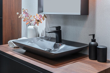 Bathroom interior with gray sink and black faucet.