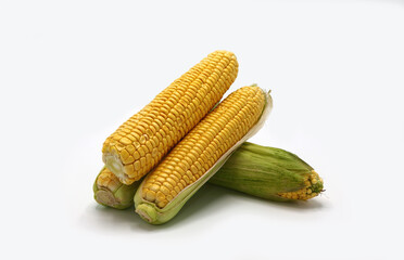 Several ears of corn on a light background. Natural product. Natural structure. Natural color. Close-up.