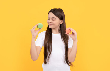 cheerful child with dessert bakery. kid hold french macaron. macaroon cookie.