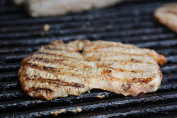 Pork Chop Cooks on Well-Used Grill