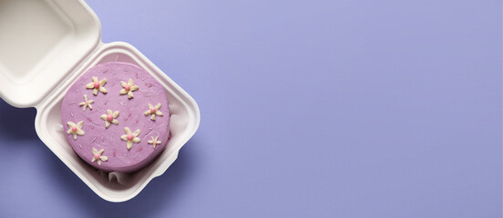 Lunch box with tasty bento cake on lilac background with space for text