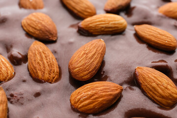 Tasty liquid chocolate with almonds, closeup