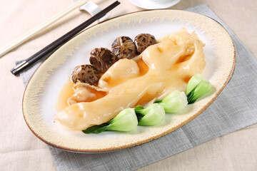Ten Head Fish Maw Grill in a dish isolated on grey background side view of Hong kong food