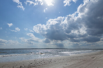 Ocean, beach and blue sky with white clouds