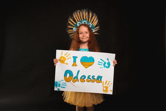 A Little Girl From Ukraine Stands In The Dark And Shakes A Poster On What Is Written In Colors I Love Odessa
