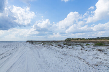 Sand beach and blue sky with white clouds