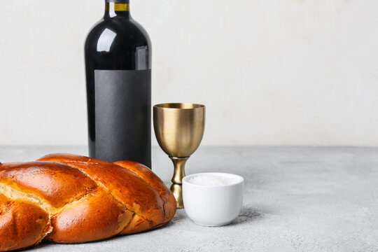 Traditional challah bread with wine on light background. Shabbat Shalom