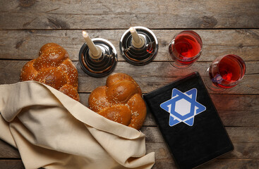 Torah with traditional challah bread, glasses of wine and candles on wooden background. Shabbat Shalom - obrazy, fototapety, plakaty