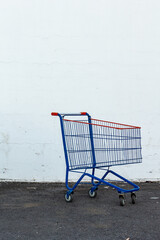 Supermarket cart isolated on parking lot with copy space.