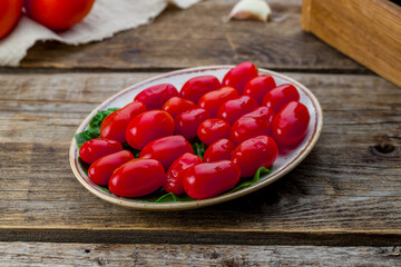 salted canned tomatoes on plate on wooden table