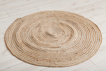 Fototapeta na wymiar Round wicker carpet on floor in living room
