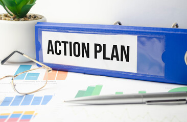 Action Plan. text on white paper. on the black folder. near the calendar