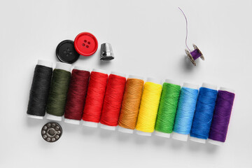 Thread spools and buttons on white background