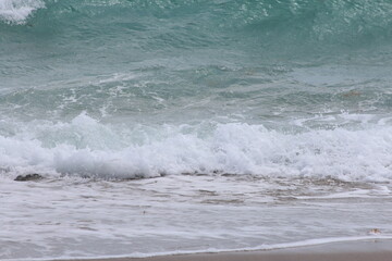 Crashing foamy waves on the beach