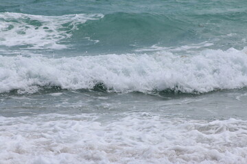 Crashing foamy waves on the beach