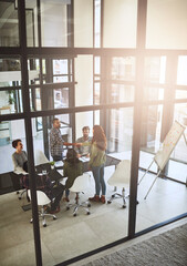 Looking forward to working together. Shot of businesspeople shaking hands in a modern office.