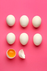 Cracked and whole chicken eggs on pink background. Concept of uniqueness