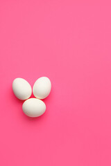 Chicken eggs on pink background