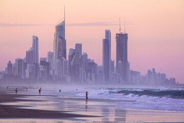 Gold Coast cityscape with people on Miami beach at sunset - obrazy, fototapety, plakaty