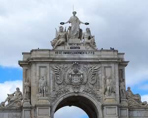Lisbon, Portugal - June 19 2019: statues and portico (arc of triumph) at Praca do Comercio, center...