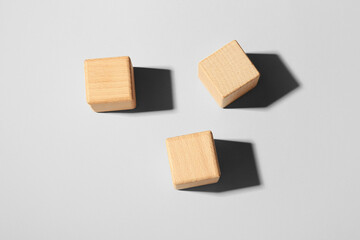 Wooden cubes on light background