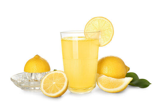 Glass of fresh lemon juice, juicer and fruits on white background