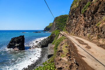 The end of Hana Highway in the southeast of Maui island, Hawaii - Winding coastal dirt road along...