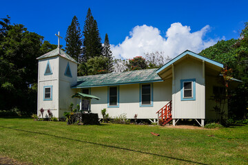 Fototapeta na wymiar Saint Paul's catholic church in Hana Highway in the southeast of Maui island, Hawaii - Wooden church on stilts in the polynesian countryside